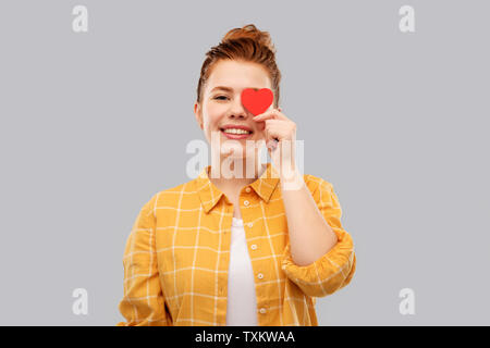 smiling red haired teenage girl with heart Stock Photo