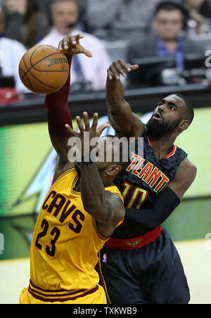 Cleveland Cavaliers' LeBron James battles Tim Hardaway Jr. of the Atlanta Hawks for a rebound during the second half at Quicken Loans Arena in Cleveland on April 7, 2017.   Photo by Aaron Josefczyk/UPI Stock Photo