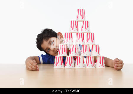 Boy building a disposable cups house Stock Photo