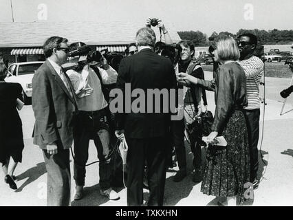 Democratic presidential candidate Arkansas Governor Bill Clinton walks through the press at the Northwest Arkansas Regional Airport after he arrived to speak at a memorial service for Wal-Mart founder Sam Walton, near Bentonville, Arkansas on April 7, 1992. UPI Stock Photo