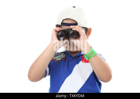 Boy looking through binoculars Stock Photo