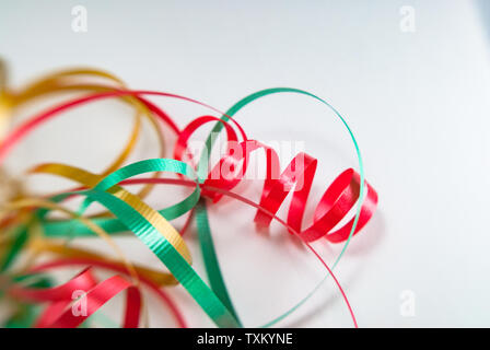 Red, gold and green wrapping ribbon curled isolated on white background. Stock Photo