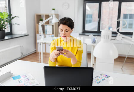 ui designer using smartphone at office Stock Photo