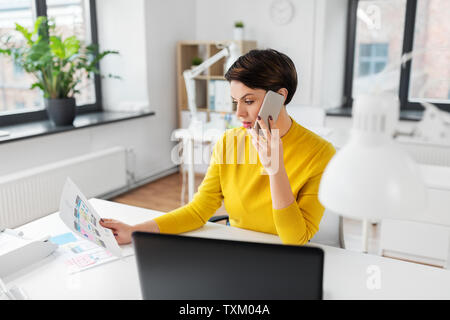 ui designer calling on smartphone at office Stock Photo
