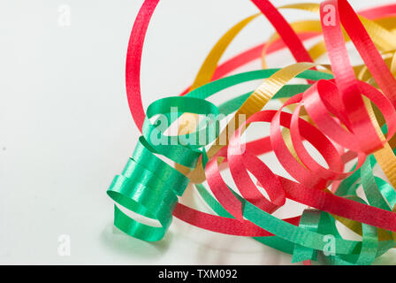 Red, gold and green wrapping ribbon curled isolated on white background. Stock Photo
