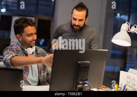 creative team with computer working late at office Stock Photo