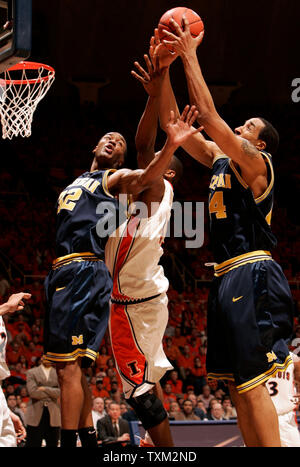 University of Michigan defenders Lester Abram  (32) and Courtney Sims (44) reach for a rebound against the University of Illinois at the University of Illinois Assembly Hall in Champaign, Il., February 21, 2007. The University of Illinois mascot Chief Illiniwek was retired by the University after the NCAA imposed sanctions for having a mascot portraying offensive use of American Indian imagery. (UPI Photo/Mark Cowan) Stock Photo