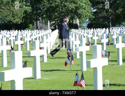 A military veteran walks among white crosses before the start of the bilateral ceremony commemorating the 70th anniversary of the D-Day landings in the Normandy region of France at the Normandy American Cemetery in Colleville-sur-Mer on June 6, 2014.   UPI/David Silpa Stock Photo