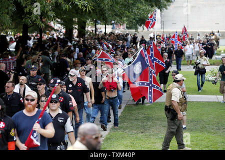 Ku Klux Klan members and Confederate battle flag supporters leave the South Carolina State House grounds after a Klan-led rally, July 18, 2015, in Columbia, South Carolina; the rally was held to protest the removal of a Confederate battle flag from the State House grounds. Photo by Veasey Conway/UPI Stock Photo