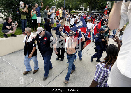 Ku Klux Klan members and Confederate battle flag supporters leave the South Carolina State House grounds after a Klan-led rally, July 18, 2015, in Columbia, South Carolina; the rally was held to protest the removal of a Confederate battle flag from the State House grounds.     Photo by Veasey Conway/UPI Stock Photo