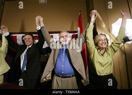Democratic National Committee Chairman Terry McAuliffe (L) Mo. Gov. Bob Holden (C) and first lady Lori Hauser Holden, raise their arms in unity during the Missouri Democratic Convention at the Columbia Expo Center in Coulmbia, Mo on April 16, 2004. Democrates from around the state are gathering to hear those running for state office and to select delegates that will represent Missouri at the National Convention in Boston in July.  (UPI Photo/Bill Greenblatt) Stock Photo