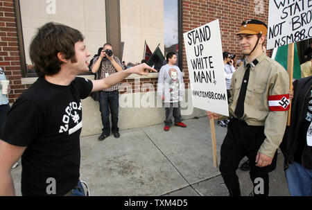 A protester taunts a member of the National Socialist Movement during their march on the campus of the University of Missouri in Columbia, Missouri on March 10, 2007. About 20 marchers were met by throngs of students that cursed them and tossed eggs into their march. (UPI Photo/Bill Greenblatt) Stock Photo