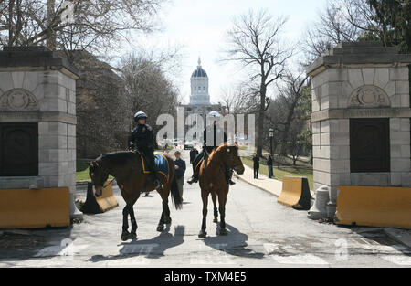 Police in riot gear on horseback guard the entrance to the University of Missouri before the start of a march by the National Socialist Movement on the campus of the University in Columbia, Missouri on March 10, 2007. About 20 marchers were met by throngs of students that cursed them and tossed eggs into their march. (UPI Photo/Bill Greenblatt) Stock Photo