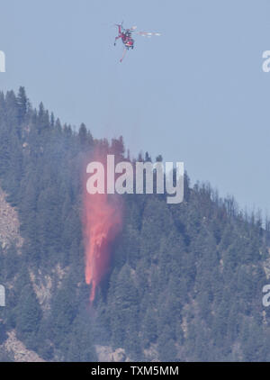 A helicopter drops retardant near the southern border of the US Air Force Academy at the Waldo Canyon fire in Colorado Springs, Colorado on June 29, 2012.  The fire is fifteen percent contained with one reported fatality and 347 home destroyed.  The fire is the most destructive in Colorado history.   UPI/Gary C. Caskey Stock Photo