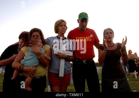 Peace demonstrators Susan House, Melanie House, James House (8 months old) Cindy Sheehan, Jeff Key and Joan Baez (l to r) sing during a gathering at sunset at Camp Casey II near U.S. President George W. Bush's Crawford, Texas ranch on Aug. 24, 2005. Sheehan, whose son Casey died in Iraq in 2003, has been camped out near the ranch hoping to meet with the President for a second time and has drawn hundreds of peace demonstrators to the site. John house died in Iraq on Jan. 26, 2005, leaving his mother Susan, wife Melanie and son James, who he never met.  (UPI Photo/Roger L. Wollenberg) Stock Photo