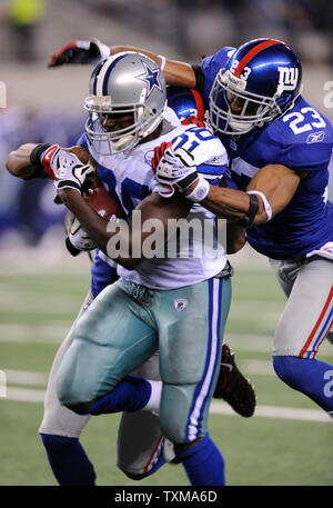 Dallas Cowboys Terrell Owens is pushed by New York Giants Corey Webster  (23) after catching a 12 yard touchdown pass in the fourth quarter at  Giants Stadium in East Rutherford, New Jersey