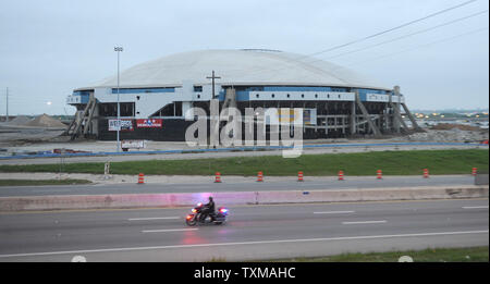 A motorcycle officer patrols the highway next to Texas Stadium, the former home of the Dallas Cowboys for 37 years, prior to its implodsion April 11, 2010.  Crews drilled more than 2,800 holes in the columns at the Irving, Texas stadium and placed nearly 2,715 pounds of explosives into the structure for detonation.    UPI/Ian Halperin. Stock Photo