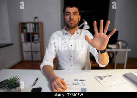 businessman using gestures at night office Stock Photo
