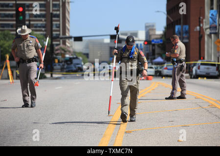 Investigators with the Texas Department of Public Safety gather evidence near Main Street during an ongoing investigation downtown where five officers were killed by a sniper in Dallas, Texas on Friday July 8, 2016.  Four DPD officers and one DART officer were killed and 11 others were wounded after a sniper opened fire during a peaceful 'Black Lives Matter' march late on July 7, 2016.   Photo by Chris McGathey/UPI Stock Photo