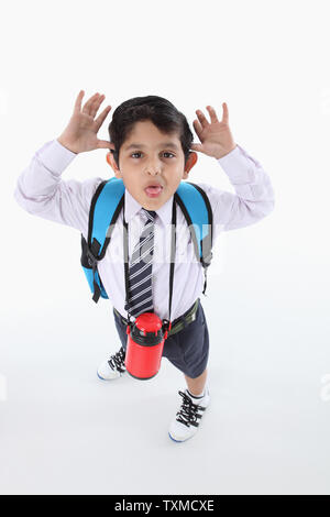High angle view of a schoolboy making a face Stock Photo