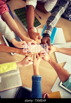 group of international students making fist bump Stock Photo