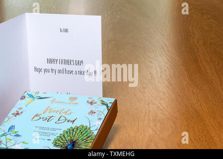 Fathers day card on wooden table with a box of chocolates. Stock Photo