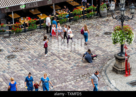 Lviv, Ukraine - July 31, 2018: Aerial high angle view below of historic Ukrainian Polish city in old town market square with crowd of people Stock Photo