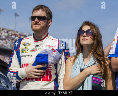 Dale Earnhardt Jr. and his girlfriend Amy Reimann during the National Anthem prior to the start of the NASCAR Sprint Cup Series Budweiser Duel #1 at Daytona International Speedway in Daytona Beach, Florida February 21, 2013. UPI/Mark Wallheiser Stock Photo