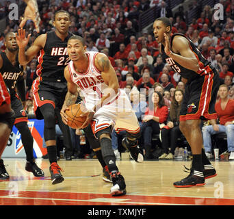 Chicago Bulls guard Derrick Rose (C) is guarded Miami Heat forward James Jones (L) and Miami Heat guard Mario Chalmers during the firstquarter of game 1 of the Eastern Conference Finals at the United Center in Chicago on May 15, 2011.     UPI/David Banks Stock Photo