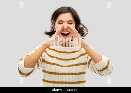 happy woman in striped pullover calling someone Stock Photo