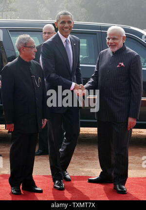 US President Barack Obama is welcomed by India's President, Shri Pranab Mukherjee (L) and Prime Minister Shri Narendra Modi (R) to a ceremonial reception at the forecourt of Rashtrapati Bhawan in New Delhi, India on January 25, 2015. President Obama is on a three day visit and will be the guest of honor at at India's Republic Day celebrations.    UPI Stock Photo