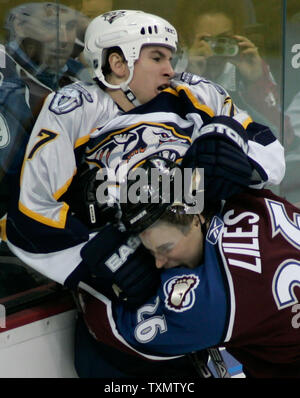 Colorado Avalanche efenseman John-Michael Liles (R) drives Nashville Predators right wing Scottie Upshall (L) into the boards at Pepsi Center in Denver, Colorado January 3, 2006.  Colorado shut out Nashville 3-0. (UPI Photo/Gary C. Caskey) Stock Photo