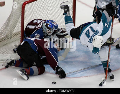 Colorado Avalanche left wing Jonathan Drouin, front, puts a shot on ...