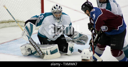 San Jose Sharks goalie Vesa Toskala (L) makes a pad save against Colorado Avalanche right wing Dan Hinote (R) at Pepsi Center in Denver April 5, 2006.  (UPI Photo/Gary C. Caskey) Stock Photo