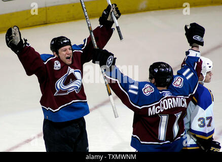 Colorado Avalanche right wing Dan Hinote (L) celebrates his goal against the St. Louis Blues with teammate Cody McCormick (C) at Pepsi Center in Denver April 8, 2006.  St. Louis Blues center Dean McAmmond (R) skates past the celebrating duo. Colorado beat St. Louis 4-2 earning two valuable points in their race to win a spot in the Western Conference playoffs.  (UPI Photo/Gary C. Caskey) Stock Photo