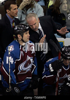 Colorado Avalanche head coach Joel Quenneville (R) talks with right wing Ian Laperriere (C) as assistant coach Tony Granato (L) stands alongside at Pepsi Center in Denver April 8, 2006.  Colorado beat St. Louis 4-2 earning two valuable points in their race to win a spot in the Western Conference playoffs.  (UPI Photo/Gary C. Caskey) Stock Photo