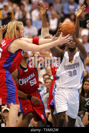 Denver Nuggets forward Reggie Evans (R) grabs a rebound from Los Angeles Clippers center Chris Kaman (L) during the first round playoffs game four at the Pepsi Center in Denver April 29, 2006.     (UPI Photo/Gary C. Caskey) Stock Photo