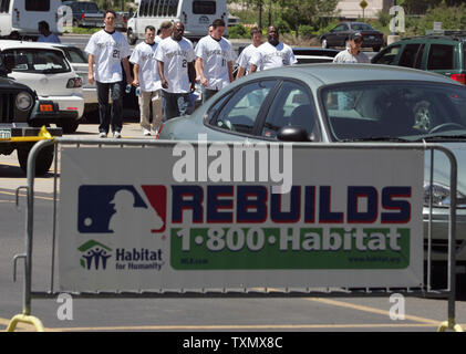 Colorado Rockies team members arrive outside Coors Field to help build a home for Hurricane Katrina, Rita, and Wilma relief in partnership with Major League baseball and Habitat for Humanity International in Denver May 16, 2006.  This home is one of twelve to be built as part of MLB initiative to contribute to the rebuilding of the Gulf Coast.   (UPI Photo/Gary C. Caskey) Stock Photo