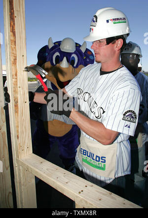 Colorado Rockies outfielder Brad Hawpe (R) and team mascot Dinger (L) help construct frame for new home for MLB and Habitat for Humanity International outside Coors Field in Denver May 16, 2006.  Major League baseball and Habitat for Humanity have partnered to build 12 home to help in the hurricane relief for the Gulf Coast after Hurricanes Katrina, Rita, and Wilma.   (UPI Photo/Gary C. Caskey) Stock Photo