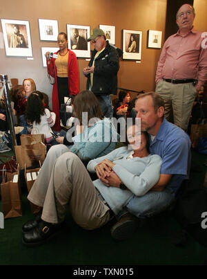 Alison Traltner (front left) and Joe Cowan (front right) wait for US Senator Barack Obama to begin his book signing at the Tattered Cover book store in Denver October 24, 2006.  Senator Obama is in Colorado promoting his book 'The Audacity of Hope' and attending a local political fundraiser.   Senator Obama has expressed the possibility of running for president in 2008.  (UPI Photo/Gary C. Caskey) Stock Photo