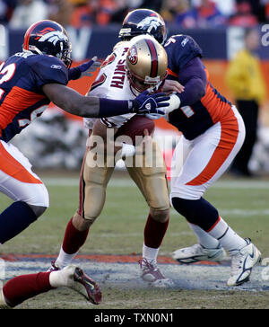 Denver Broncos' Elvis Dumervil (92) kneels on the ground after the ...