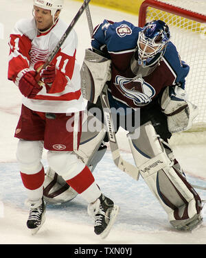 Detroit Red Wings right wing Dan Cleary (L) tries to deflect a shot past Colorado Avalanche goalie Peter Budaj (R) of Slovakia in the first period at the Pepsi Center in Denver January 20, 2007.   (UPI Photo/Gary C. Caskey) Stock Photo