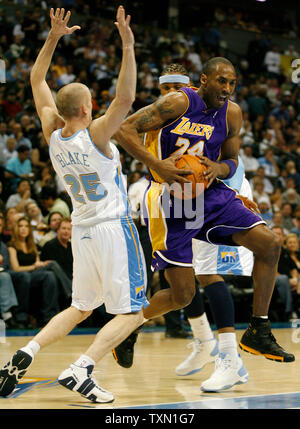 Los Angeles Lakers guard Kobe Bryant leaps past Denver Nuggets guard Steve Blake (L) in the first quarter at the Pepsi Center in Denver April 9, 2007.  Denver currently holds the Western Conference's  sixth playoff spot with Los Angeles in seventh position.    (UPI Photo/Gary C. Caskey) Stock Photo