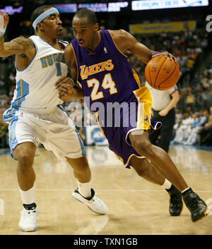 Los Angeles Lakers guard Kobe Bryant (R) drives against Denver Nuggets guard J.R. Smith during the second quarter at the Pepsi Center in Denver April 9, 2007.  Denver currently holds the Western Conference's  sixth playoff spot with Los Angeles in seventh position.    (UPI Photo/Gary C. Caskey) Stock Photo