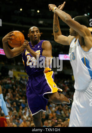 Los Angeles Lakers guard Kobe Bryant (L) drives against Denver Nuggets center Marcus Camby during the first quarter at the Pepsi Center in Denver April 9, 2007.  Denver currently holds the Western Conference's  sixth playoff spot with Los Angeles in seventh position.    (UPI Photo/Gary C. Caskey) Stock Photo