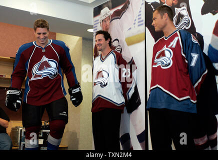 L-R) Colorado Avalanche head coach Joel Quenneville, former Avalanche  Curtis Leschyshyn, and Avalanche forward Milan Hejduk watch the unveiling  of the new Avalanche uniform during a press conference at the Pepsi Center