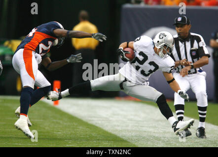 Denver Broncos CB Champ Bailey (L) hangs his head alongside