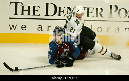 Colorado Avalanche right wing Ben Guite (L) takes the puck away from Dallas Stars left wing Loui Eriksson of Sweden during the first period at the Pepsi Center in Denver on October 3, 2007.   (UPI Photo/Gary C. Caskey) Stock Photo