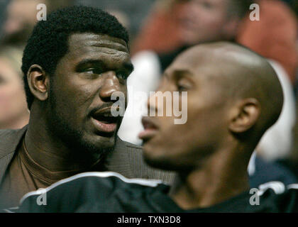 Portland Trailblazers number one draft choice center Greg Oden (L) sits behind the bench in the first half against the Denver Nuggets at the Pepsi Center in Denver on November 14, 2007. Oden underwent surgery and will miss his entire rookie season.  (UPI Photo/Gary C. Caskey) Stock Photo