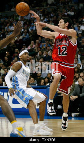 Chicago Bulls guard Kirk Hinrich (R) passes over Denver Nuggets guard Allen Iverson during the first quarter at the Pepsi Center in Denver on November 20, 2007.   (UPI Photo/Gary C. Caskey) Stock Photo